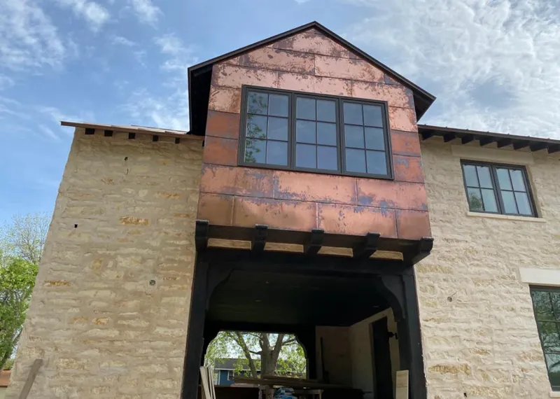 Copper metal panel facade on a stone building for Metal Roof Coating in Goshen